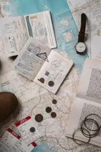 Travel map, passport and tickets laid out, representing the traveller journey
