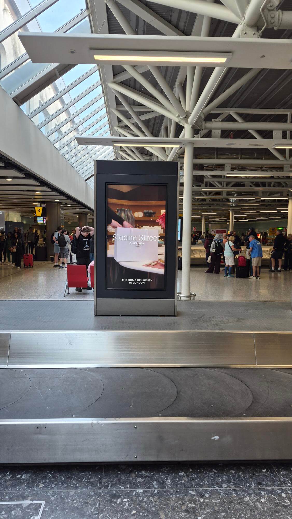 Sloane Street x L'Objet product creative, airport OOH advertising on a digital totem unit at London Heathrow arrivals hall, Terminal 3